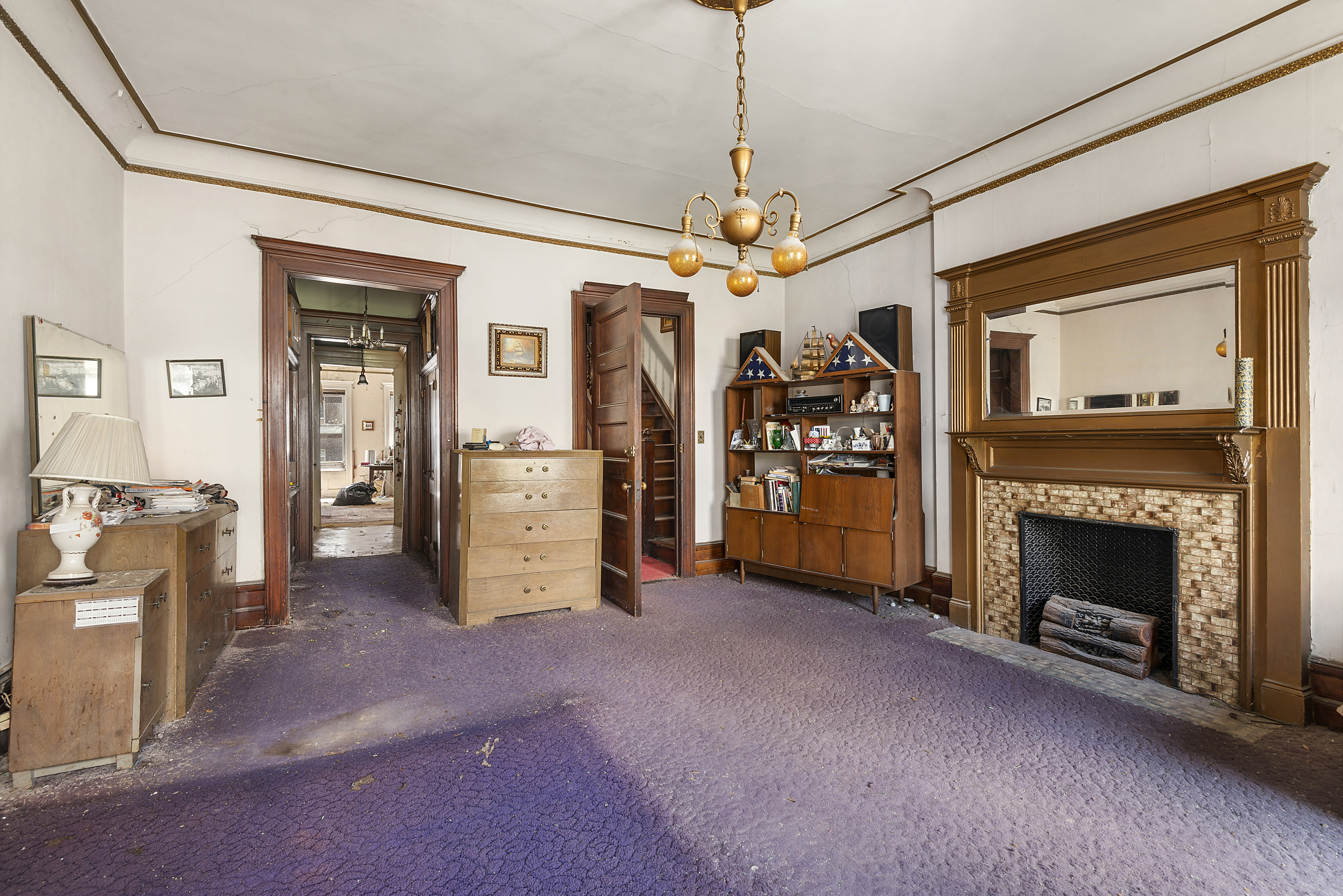 32 West 85th Street Manhattan, NY 10024 - Photo 8 of 10 a view of a livingroom with an empty space and a fireplace