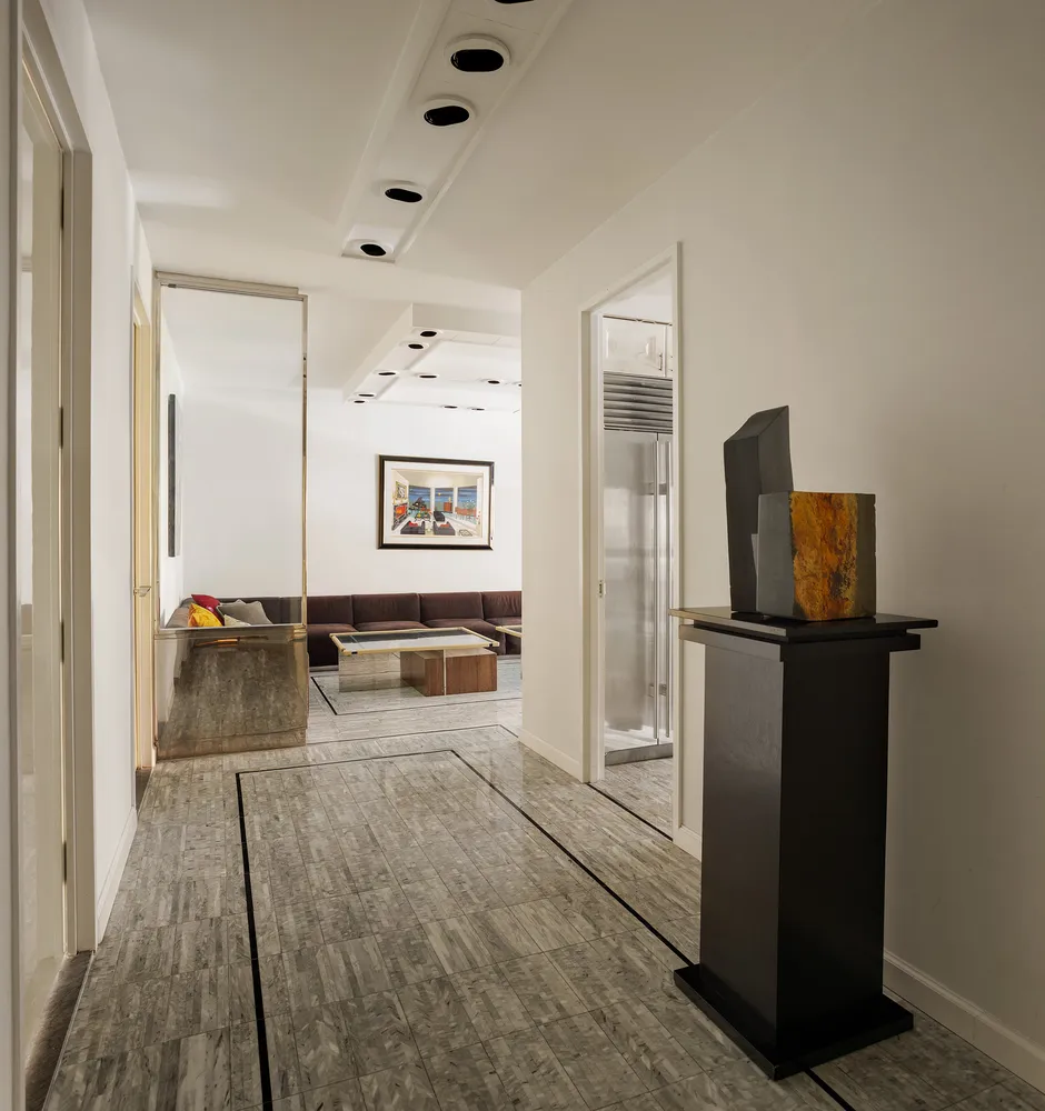 a room with a refrigerator and television