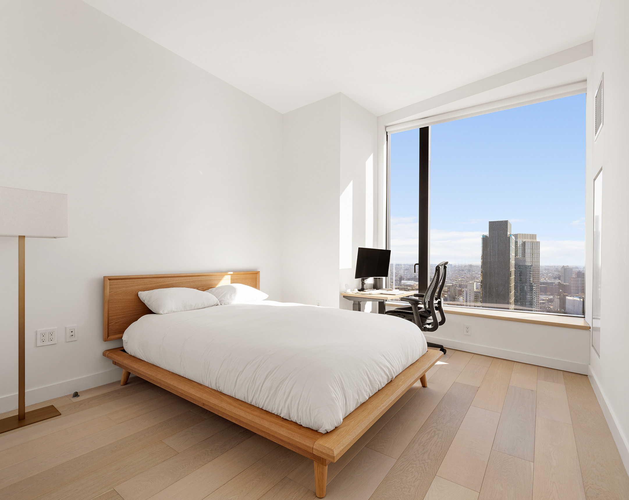 11 Hoyt Street, Unit 42C Brooklyn, NY 11201 - Photo 5 of 15 a bedroom with a bed a table and a large mirror next to a window