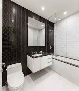 a bathroom with a sink a toilet and mirror