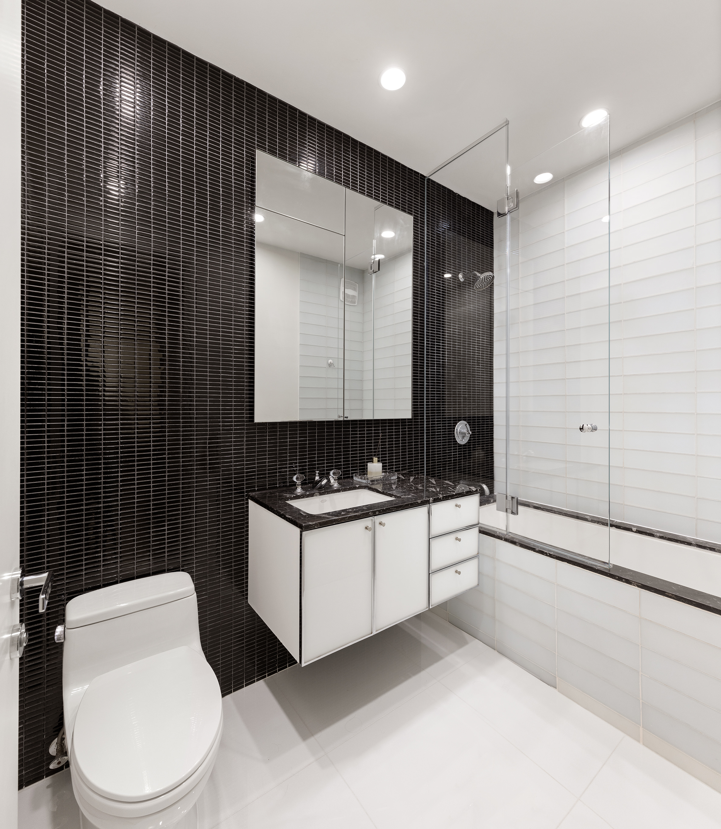 25 Broad Street, Unit 6T Manhattan, NY 10004 - Photo 7 of 13 a bathroom with a sink a toilet and mirror