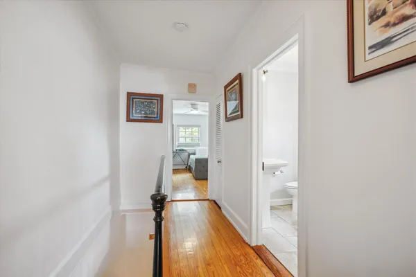 a view of a hallway with wooden floor and workspace