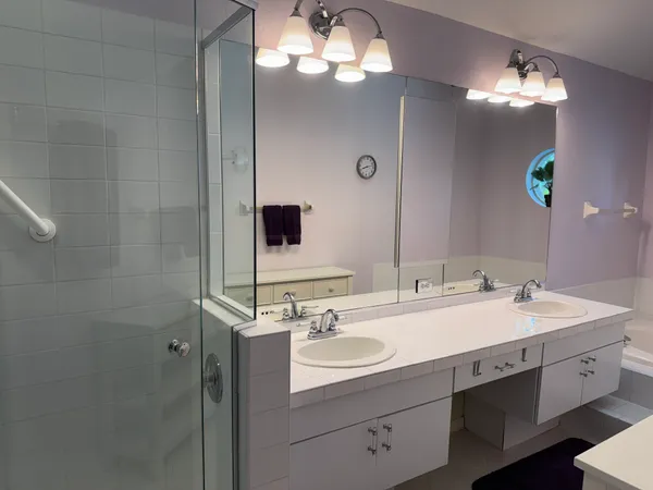 a bathroom with a sink double vanity and a mirror