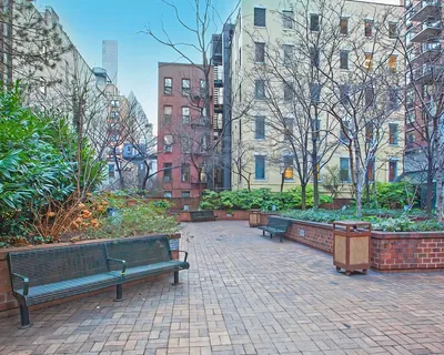 a wooden bench sitting in front of a building