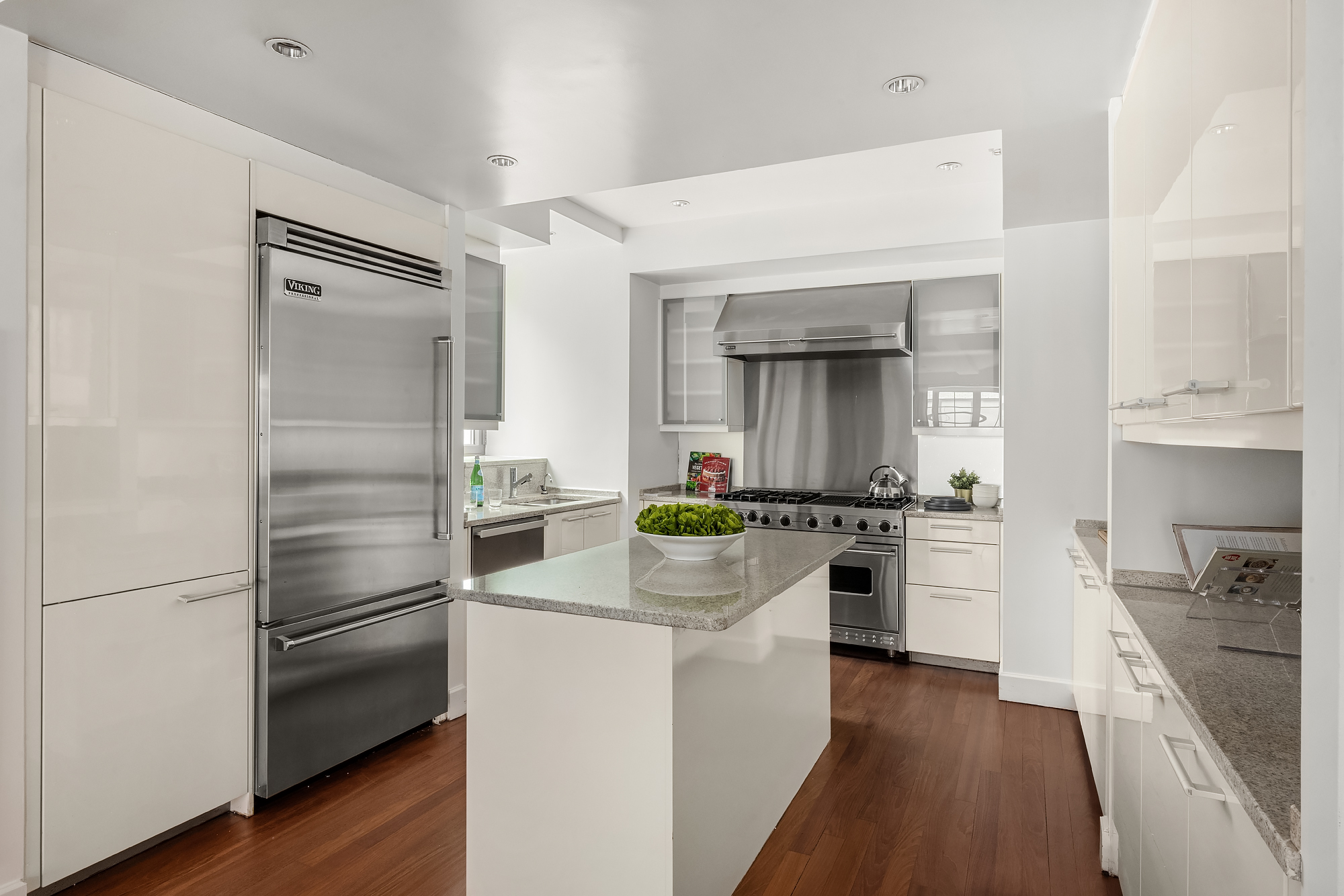 43 West 64th Street, Unit 7A Manhattan, NY 10023 - Photo 8 of 20 a kitchen with a refrigerator stove and sink