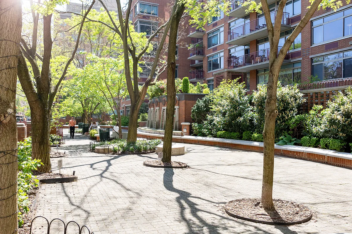 99 Jane Street, Unit 4H Manhattan, NY 10014 - Photo 19 of 22 a street sign on a sidewalk next to a road