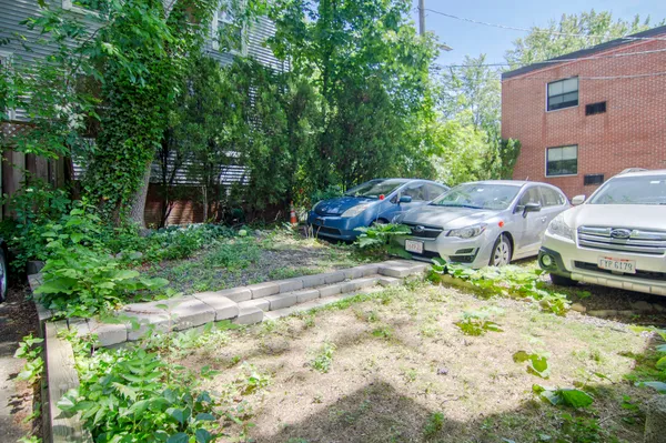 a backyard of a house with table and chairs