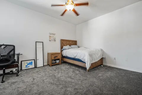 a spacious bedroom with a bed and a chandelier