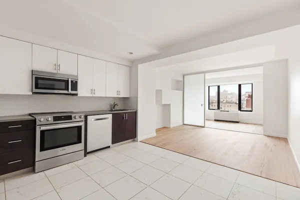 a large white kitchen with white cabinets