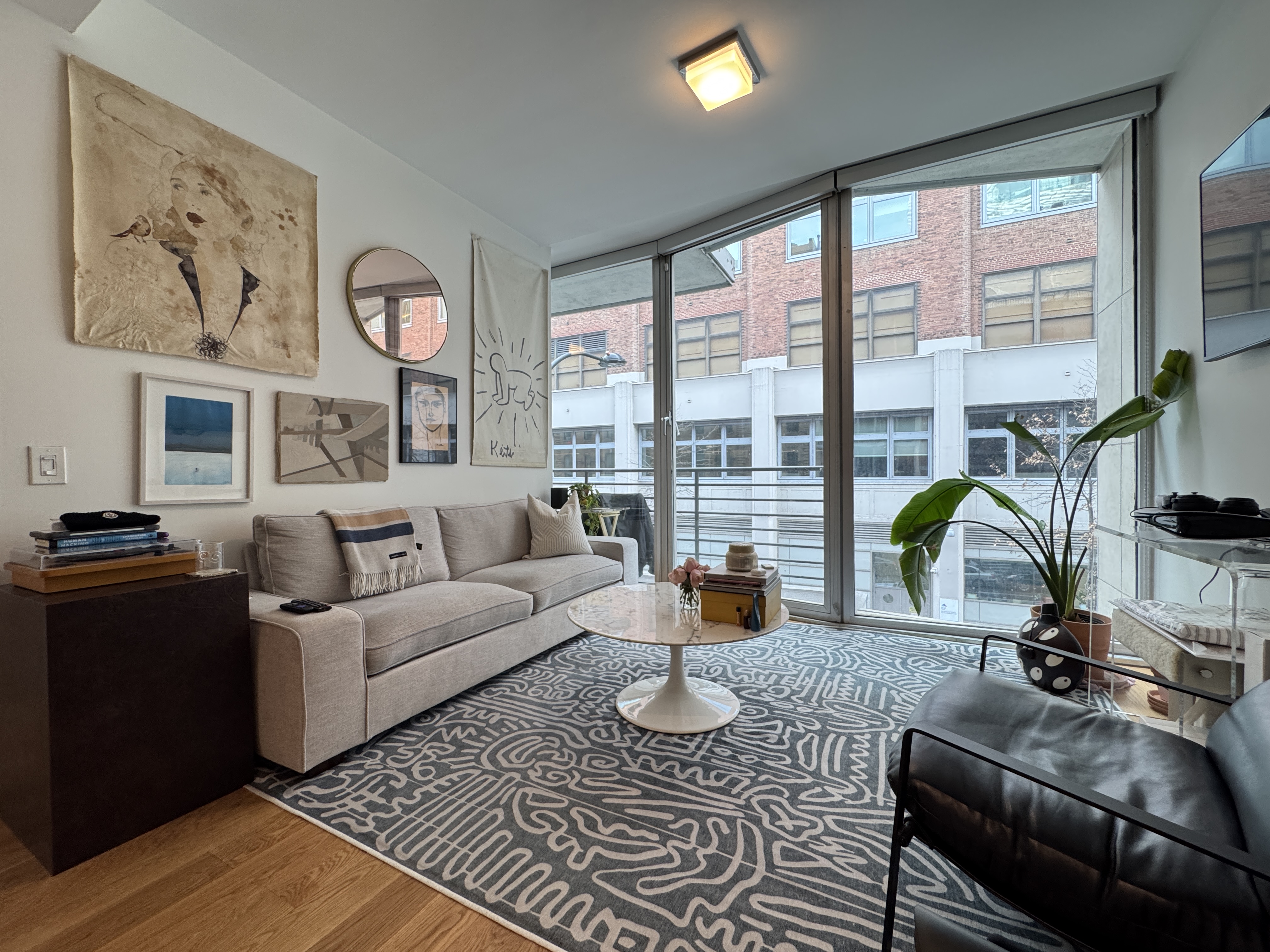 a living room with furniture large window and outer view