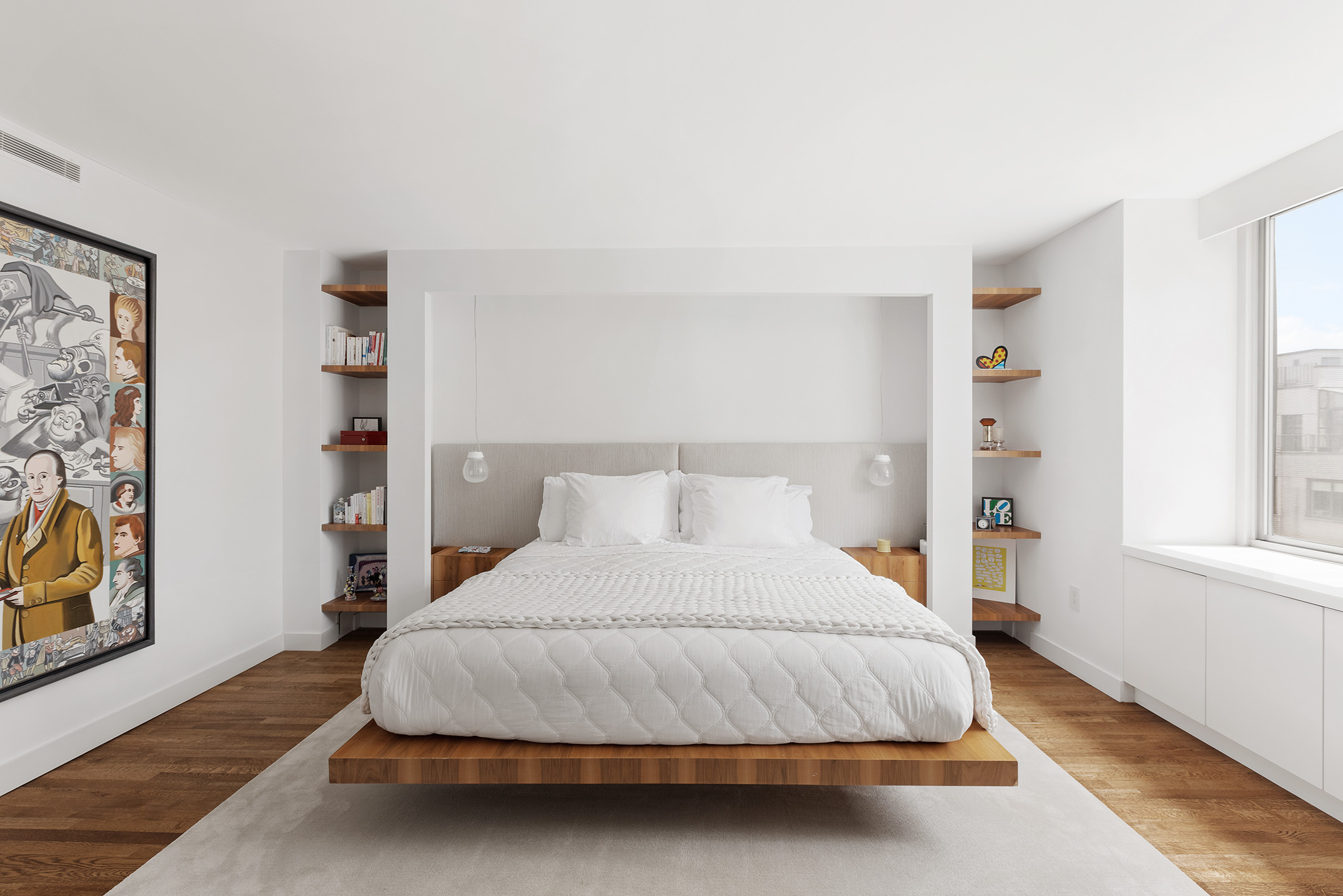 525 East 80th Street, Unit 11BC Manhattan, NY 10075 - Photo 8 of 16 a bedroom with a bed lamp and paintings on the wall