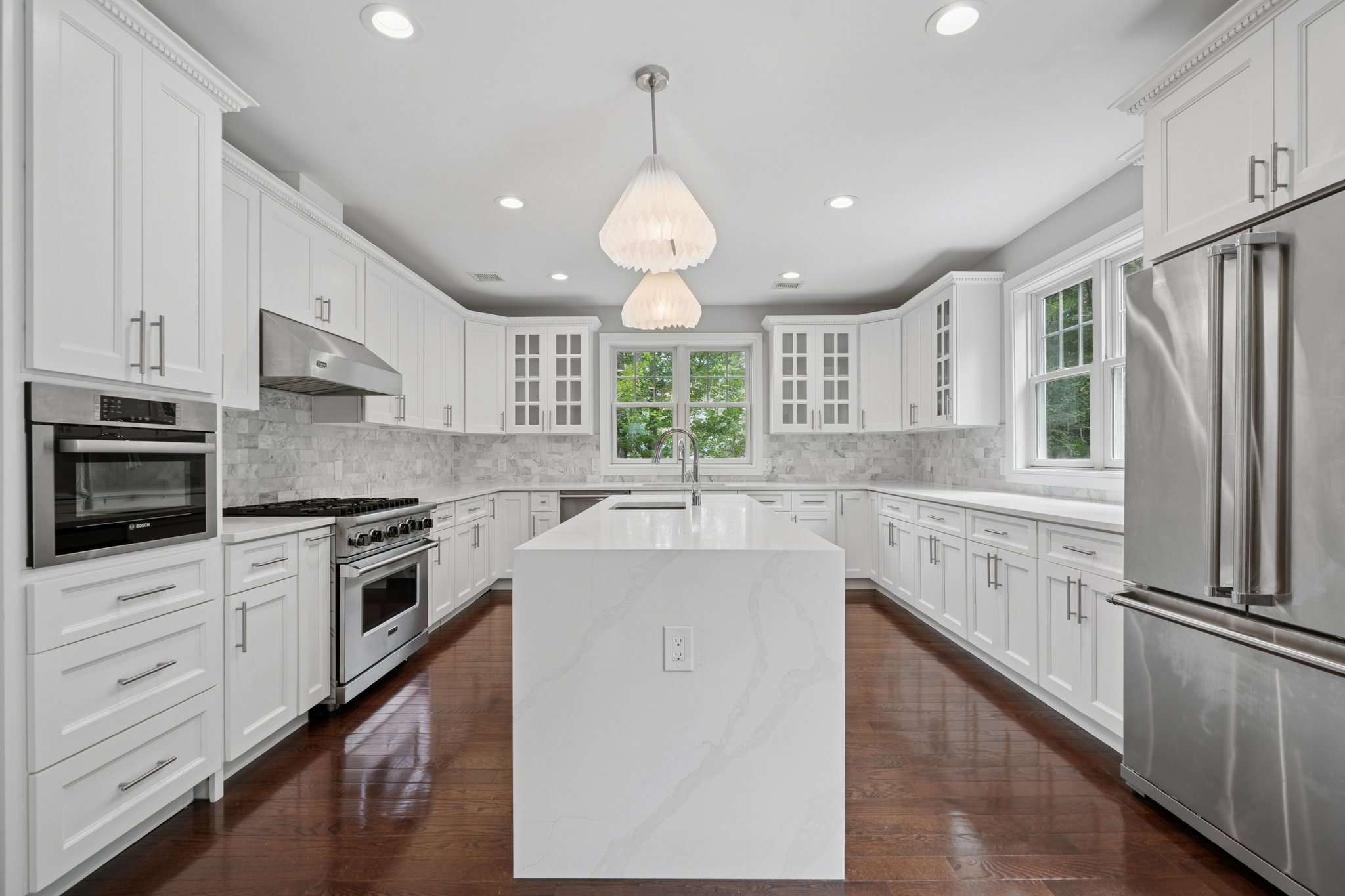 823 River Road Chatham, NJ 07928 - Photo 11 of 60 a large kitchen with granite countertop a stove a sink dishwasher a refrigerator and white cabinets with wooden floor