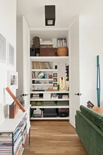 a living room with furniture and a lamp