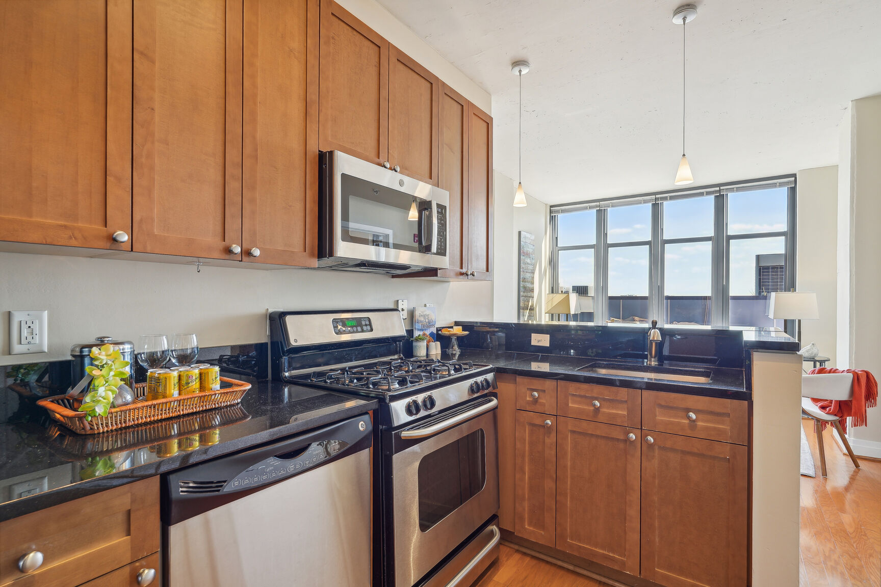 2120 Vermont Avenue Northwest, Unit 620 Washington, DC 20001 - Photo 16 of 61 a kitchen with stainless steel appliances a stove sink microwave and cabinets