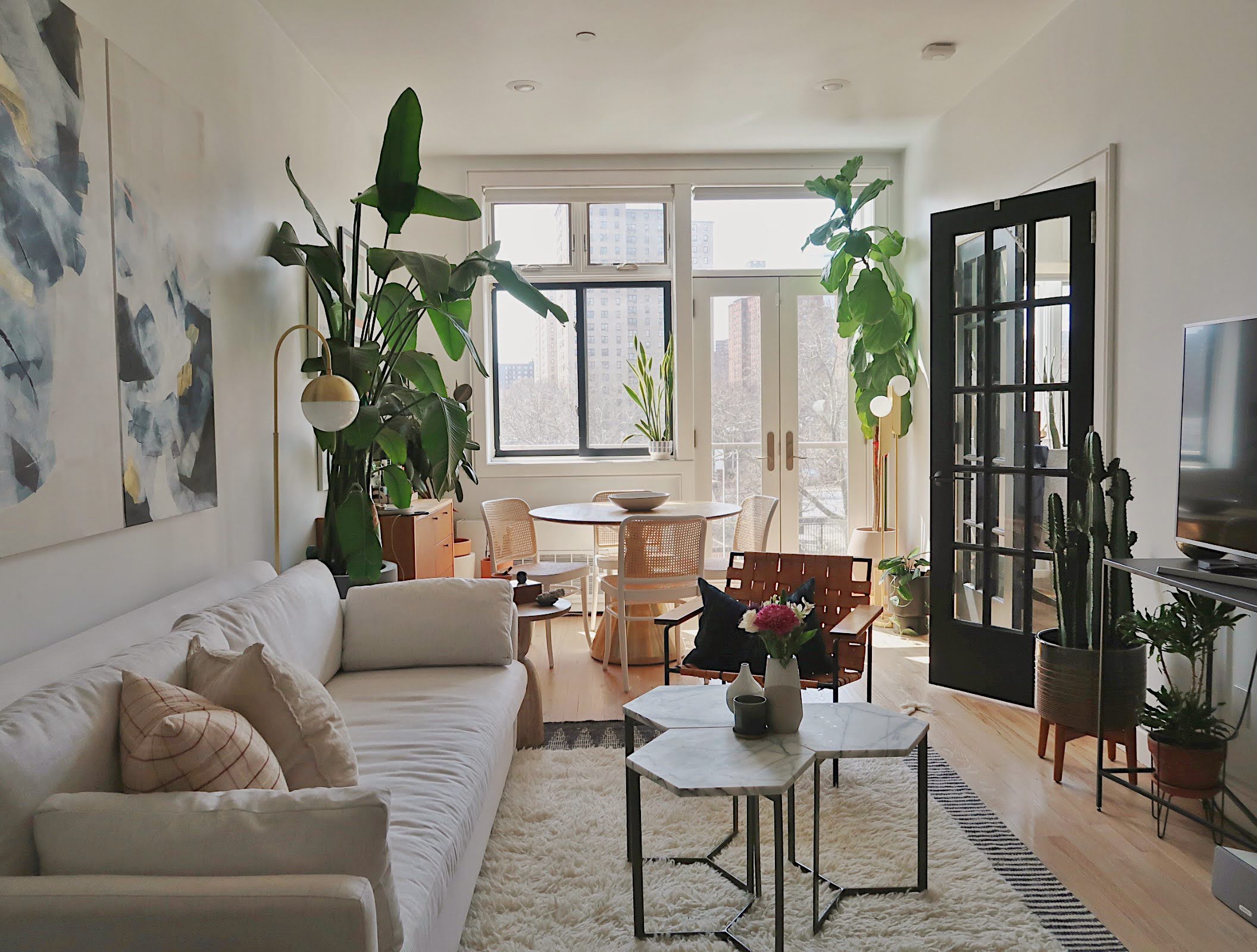 296 East 2nd Street, Unit 4G Manhattan, NY 10009 - Photo 2 of 14 a living room with furniture and a potted plant