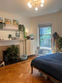 a bedroom with a bed and a window