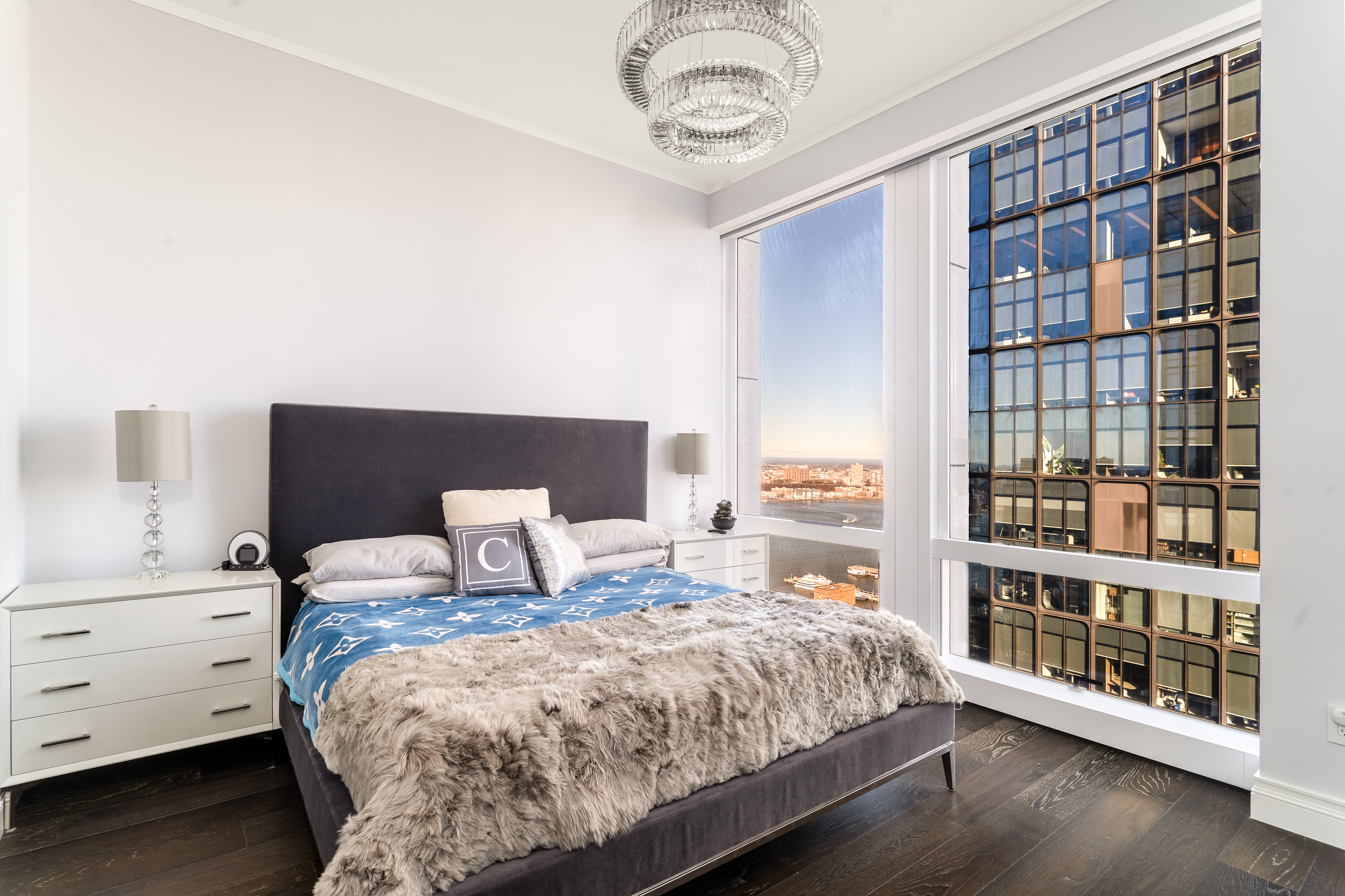 35 Hudson Yards, Unit 5903 Manhattan, NY 10001 - Photo 8 of 15 a bedroom with a large bed and a book shelf