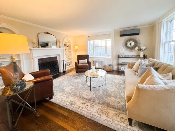 a living room with furniture fireplace and a table