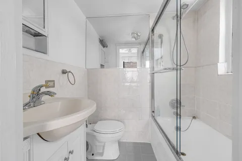 a bathroom with a toilet sink and shower