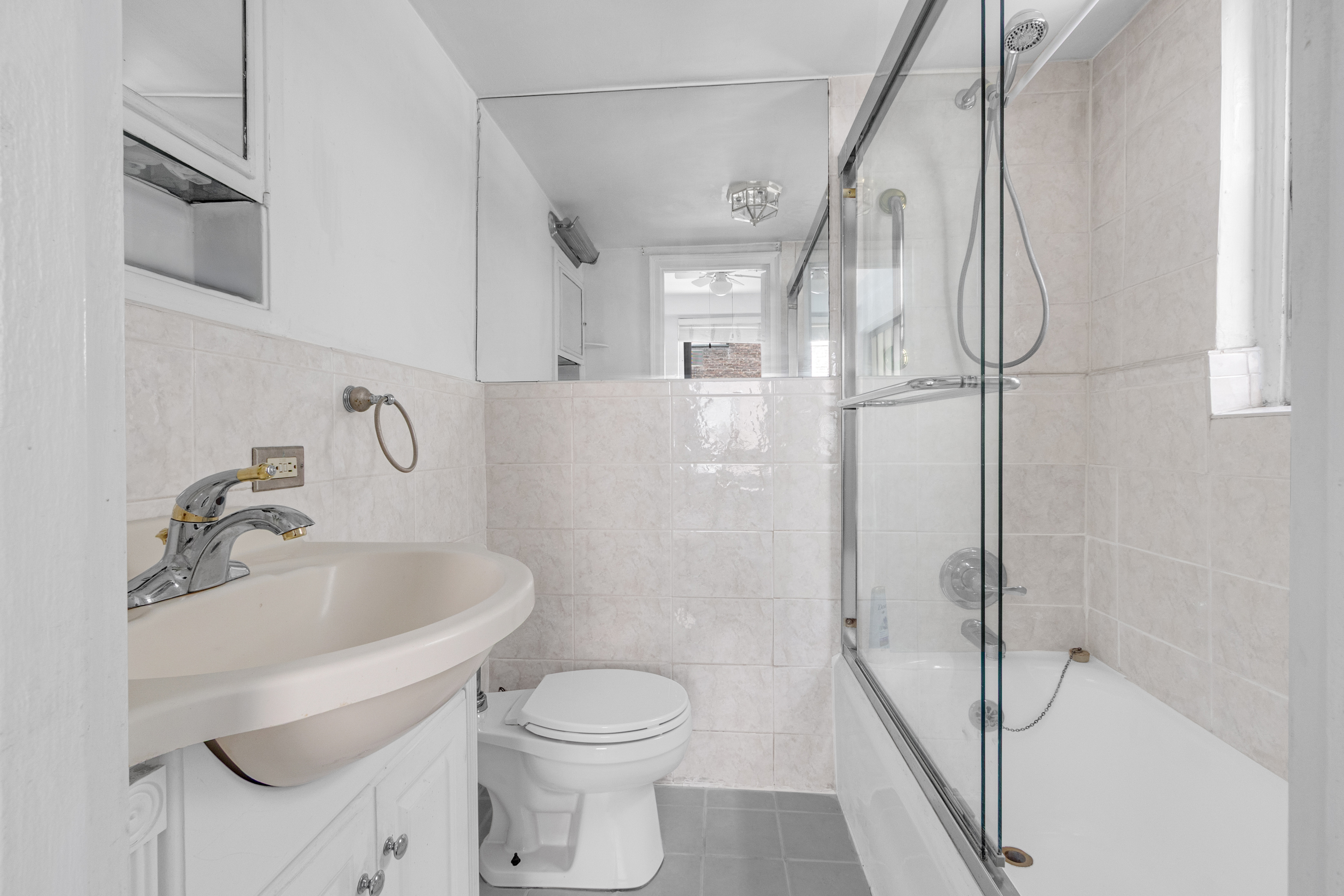 155 East 49th Street, Unit 3EE Manhattan, NY 10017 - Photo 5 of 8 a bathroom with a toilet sink and shower