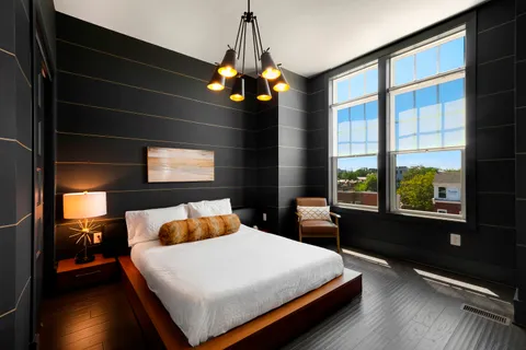 a bedroom with a large bed and a large window
