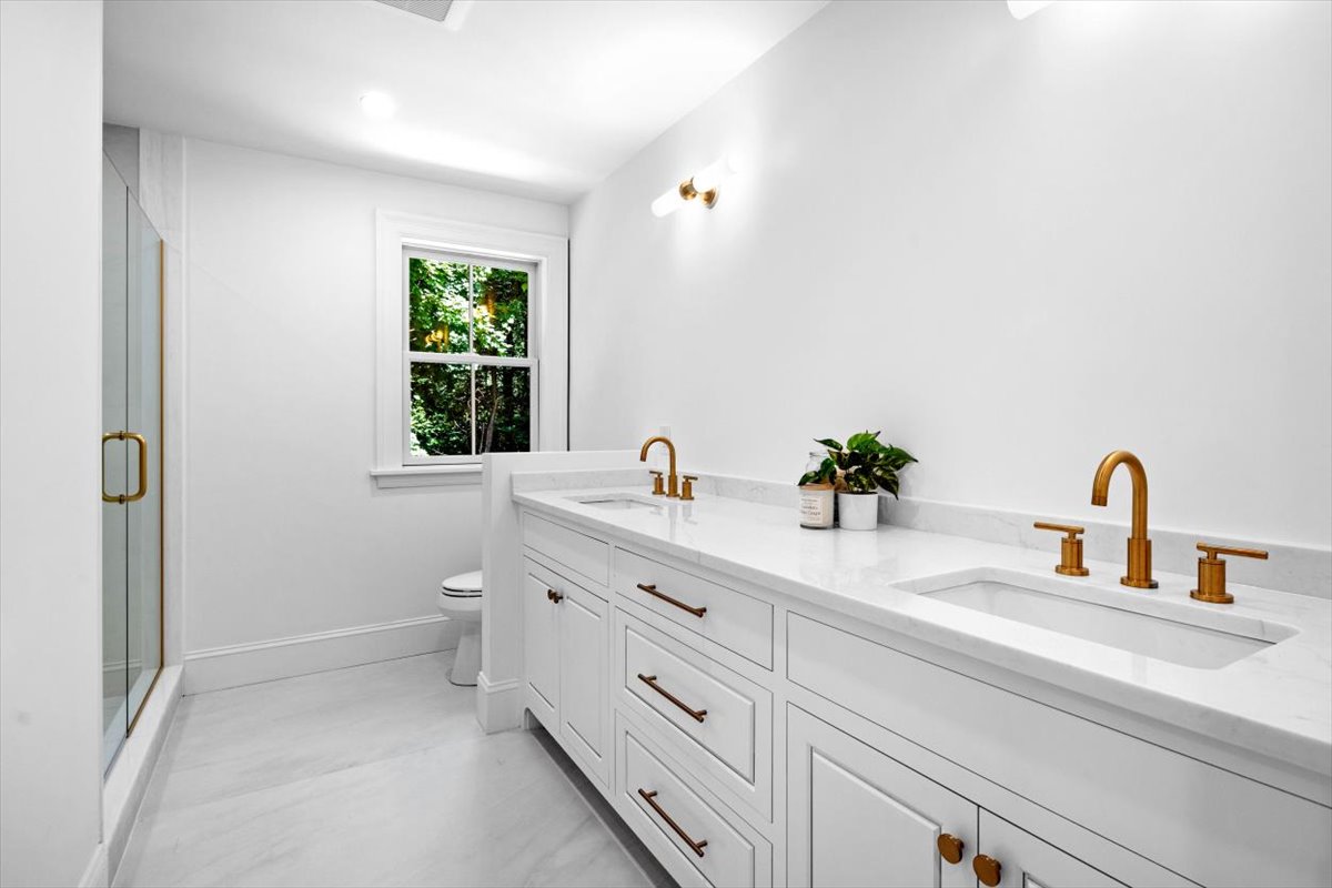 49 Garrison Road Hingham, MA 02043 - Photo 17 of 30 a bathroom with a double vanity sink toilet and a window
