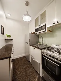 a kitchen with granite countertop a stove and a sink