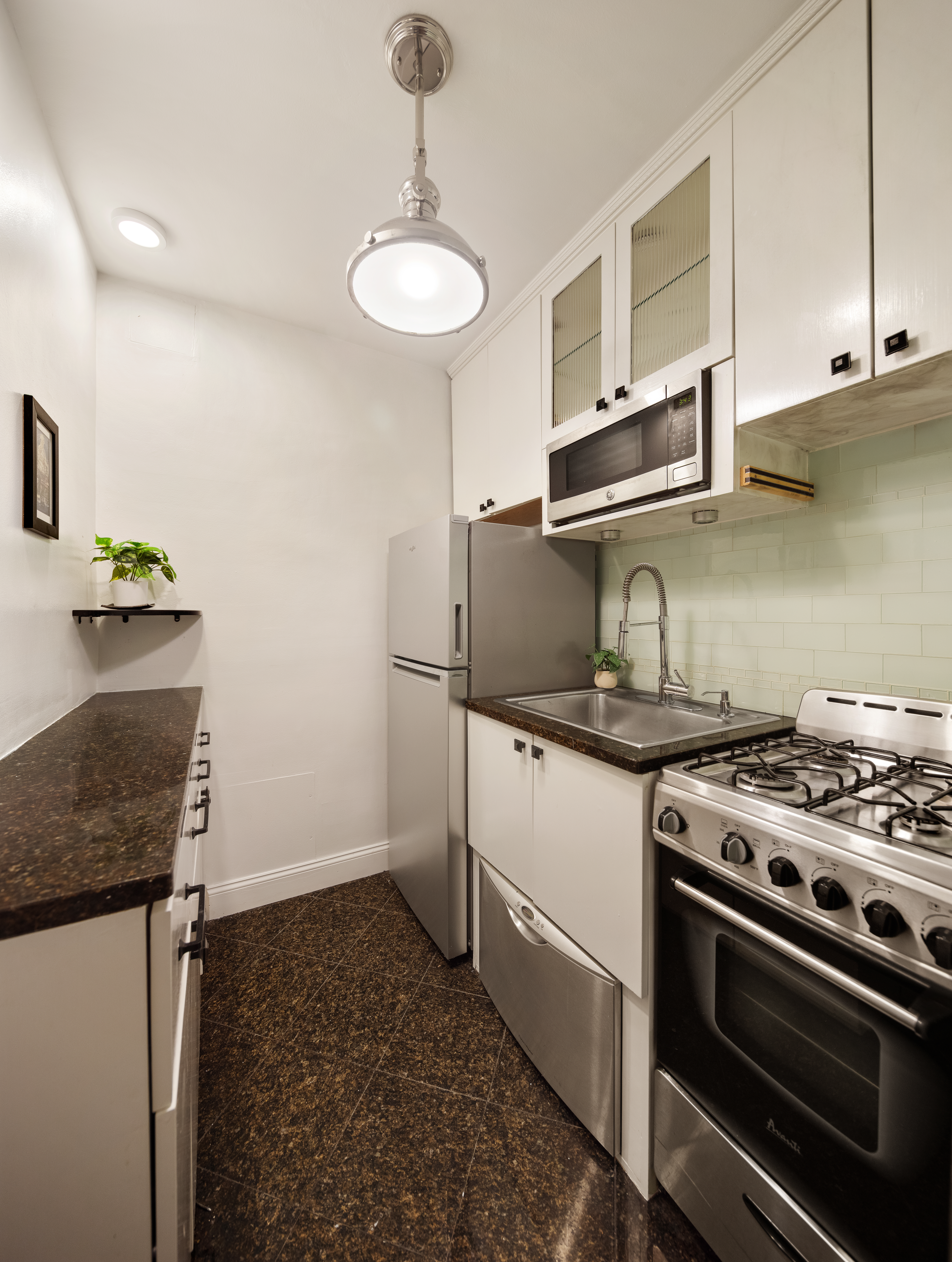 88 Bleecker Street, Unit 6A Manhattan, NY 10012 - Photo 4 of 7 a kitchen with granite countertop a stove and a sink