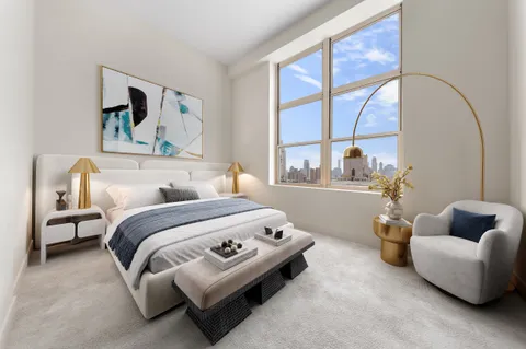 a bedroom with bed and a large window