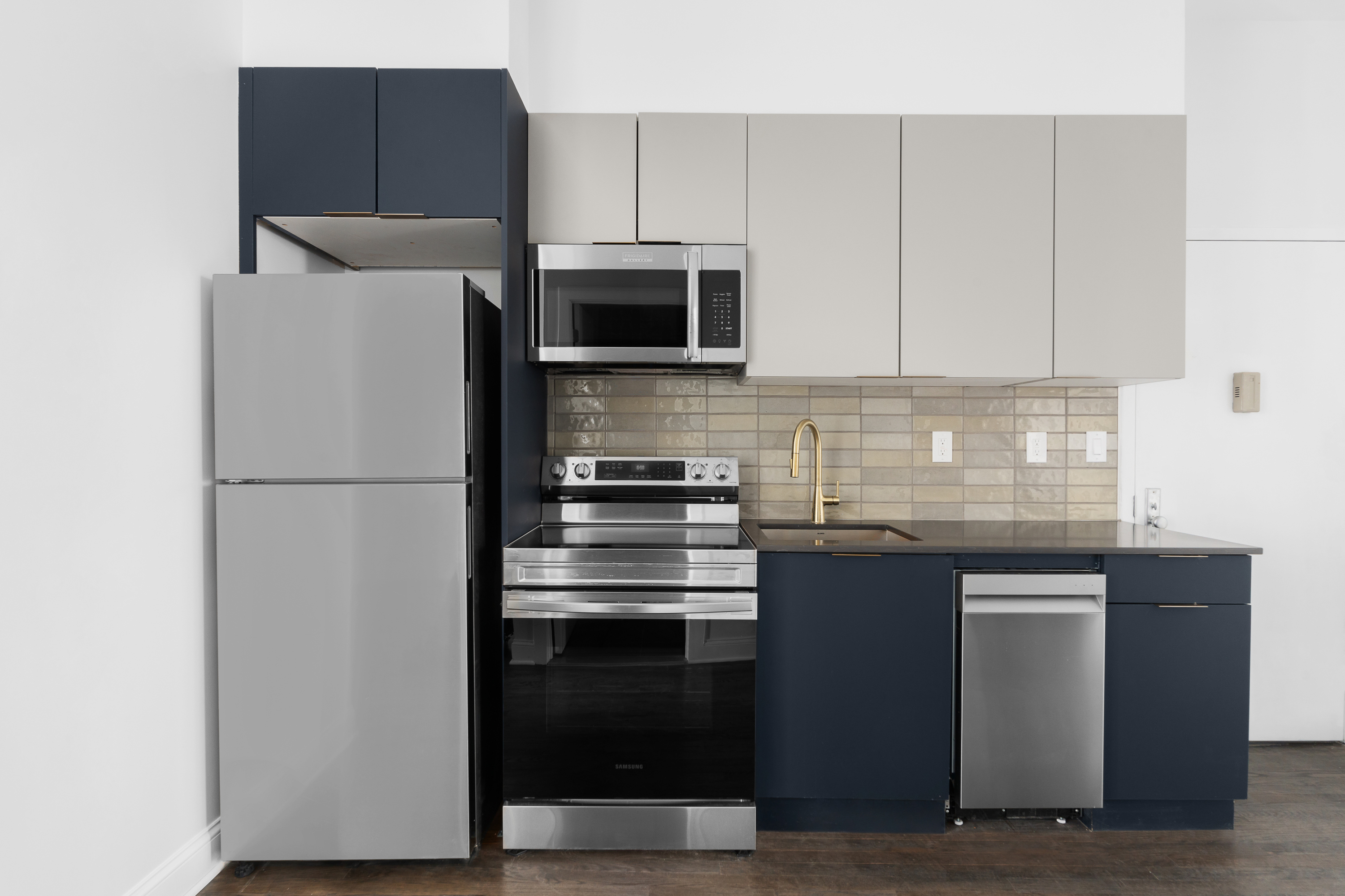 92 Wilson Avenue Brooklyn, NY 11237 - Photo 7 of 15 a kitchen with a refrigerator and a stove