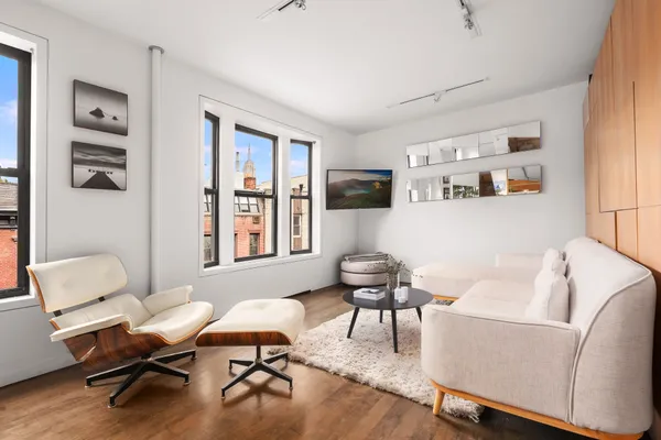 a living room with furniture window and wooden floor