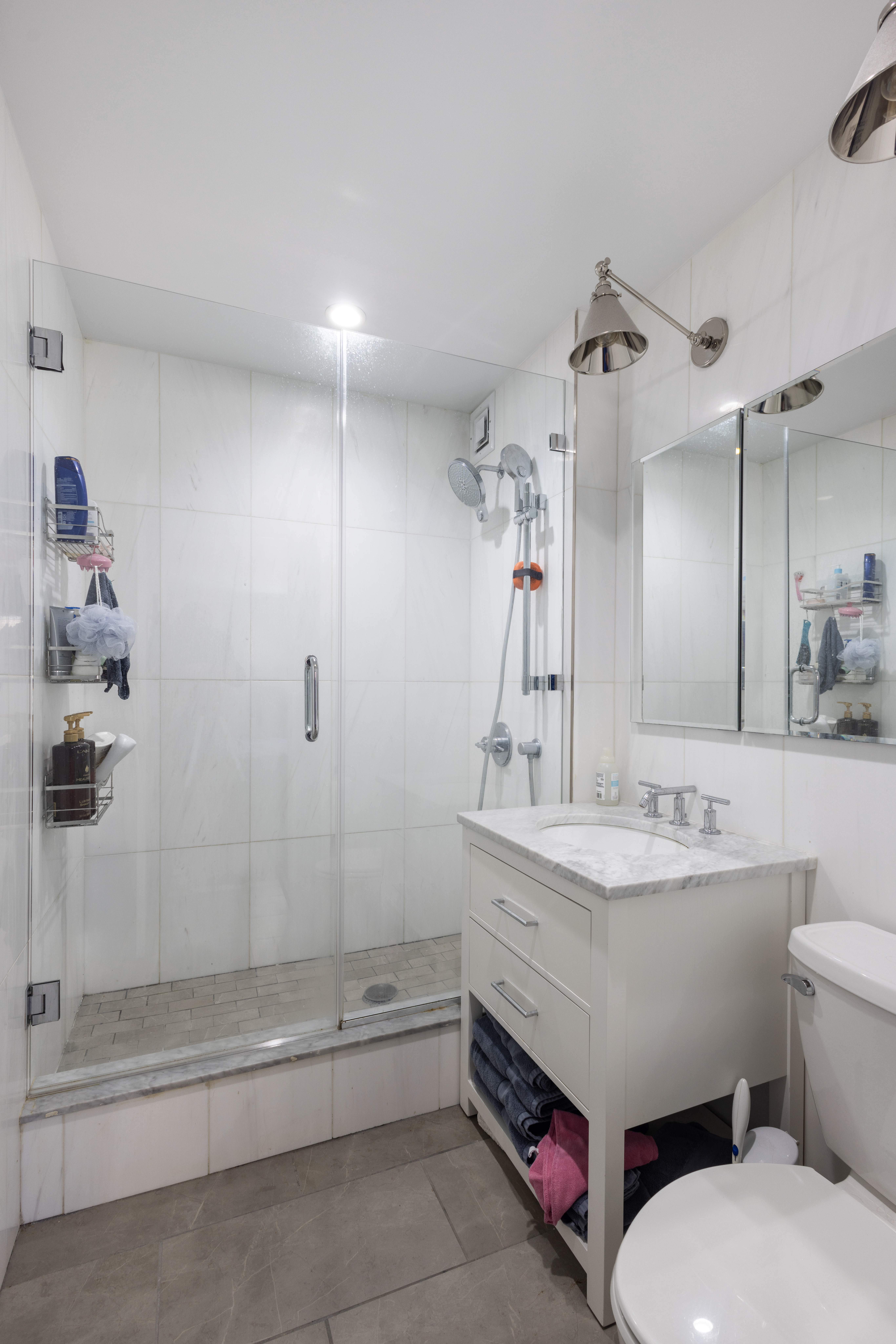 1330 5th Avenue, Unit 6C Manhattan, NY 10026 - Photo 8 of 16 a bathroom with a sink a toilet and shower