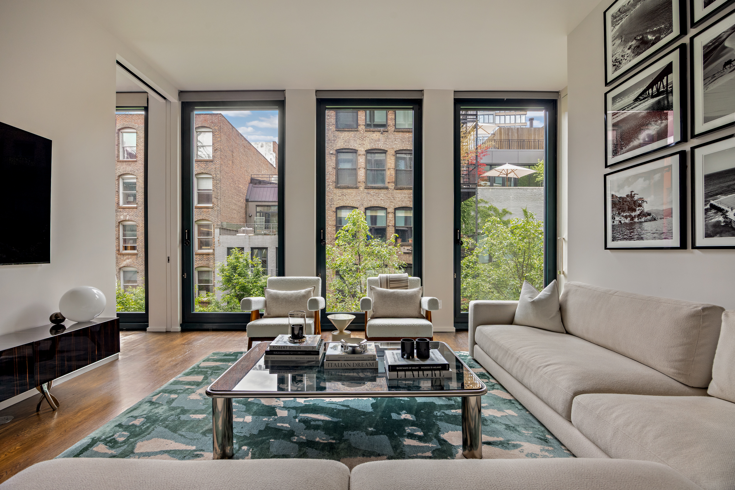 40 Bond Street, Unit 6D Manhattan, NY 10012 - Photo 2 of 23 a living room with furniture large window and flat screen tv