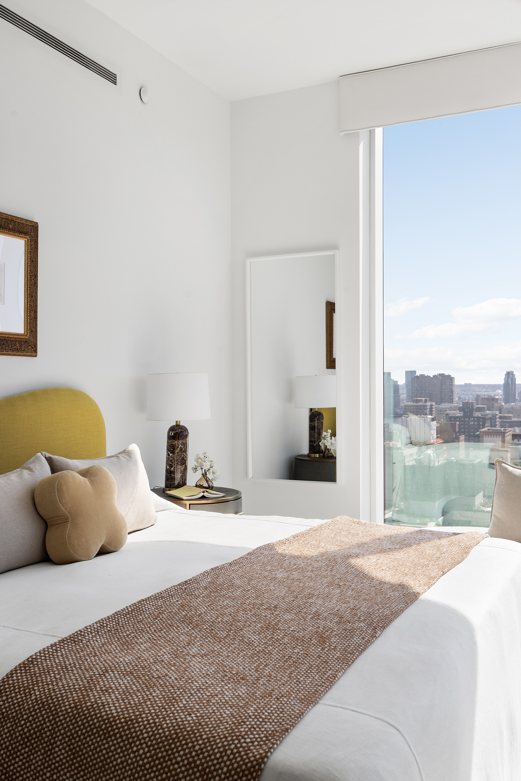 45 East 22nd Street, Unit 32B Manhattan, NY 10010 - Photo 23 of 36 a bedroom with a bed and lamp