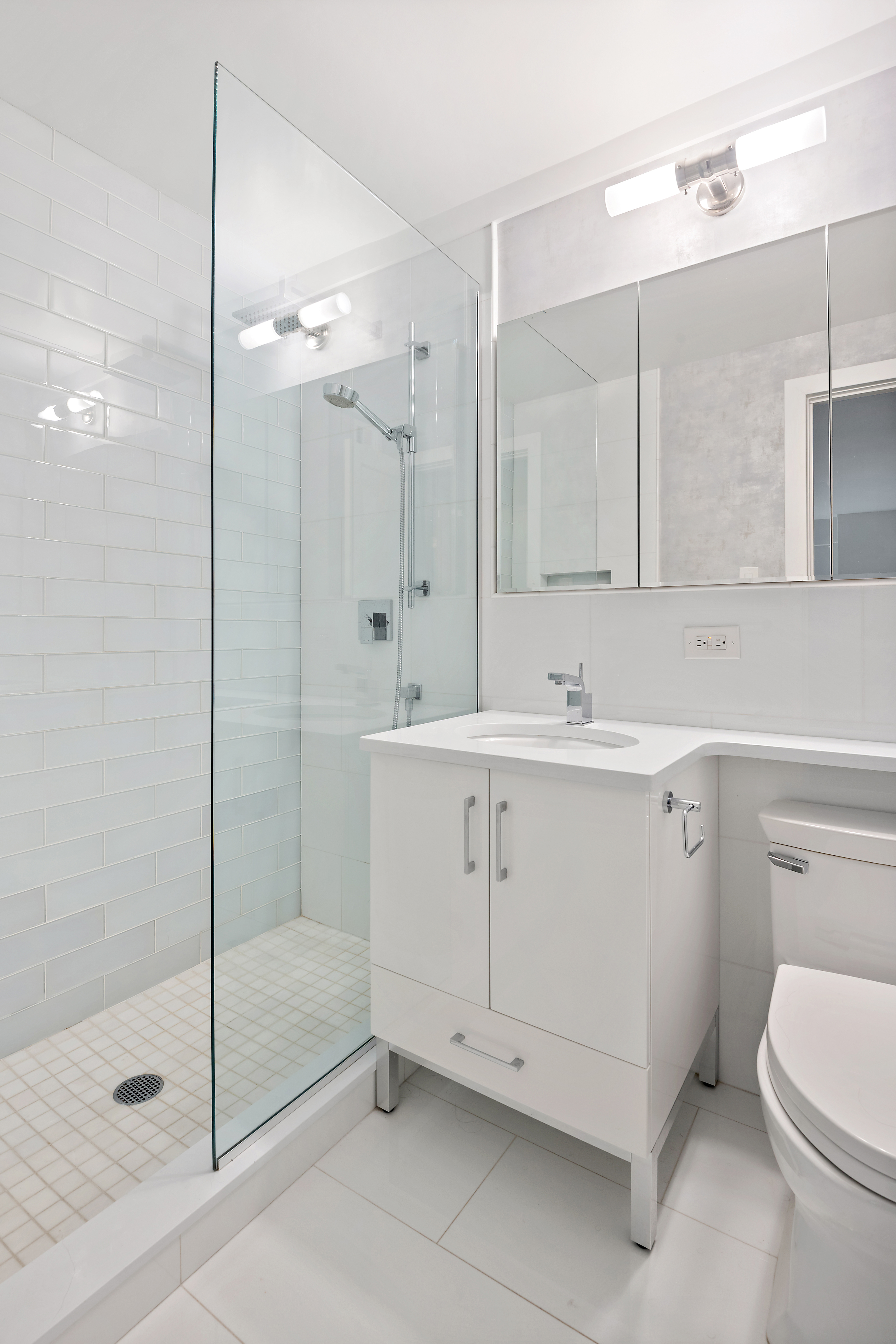 440 East 56th Street, Unit 8C Manhattan, NY 10022 - Photo 4 of 14 a bathroom with a sink a toilet and shower