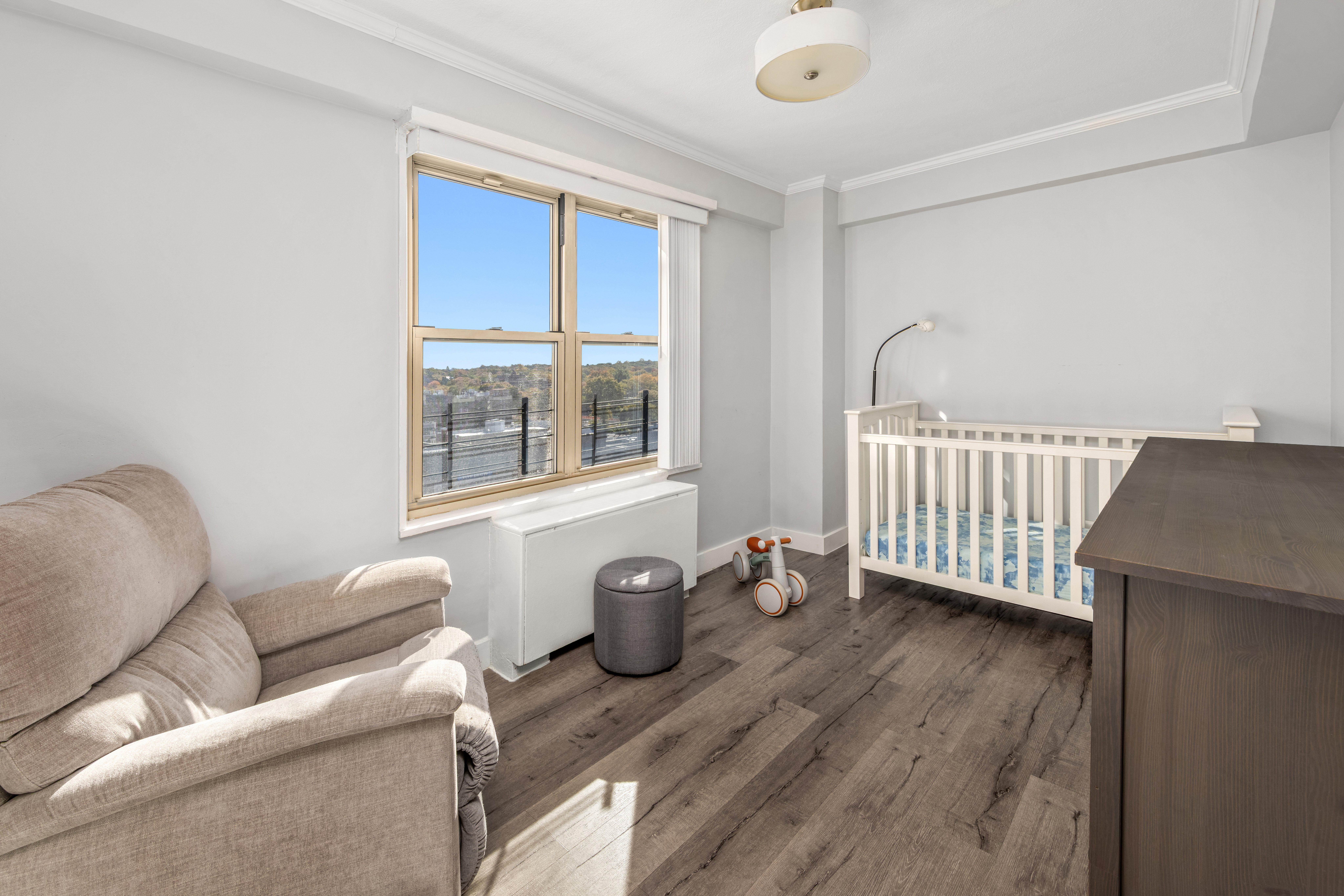 107-40 Queens Boulevard, Unit 11A Queens, NY 11375 - Photo 5 of 10 a living room with furniture and wooden floor