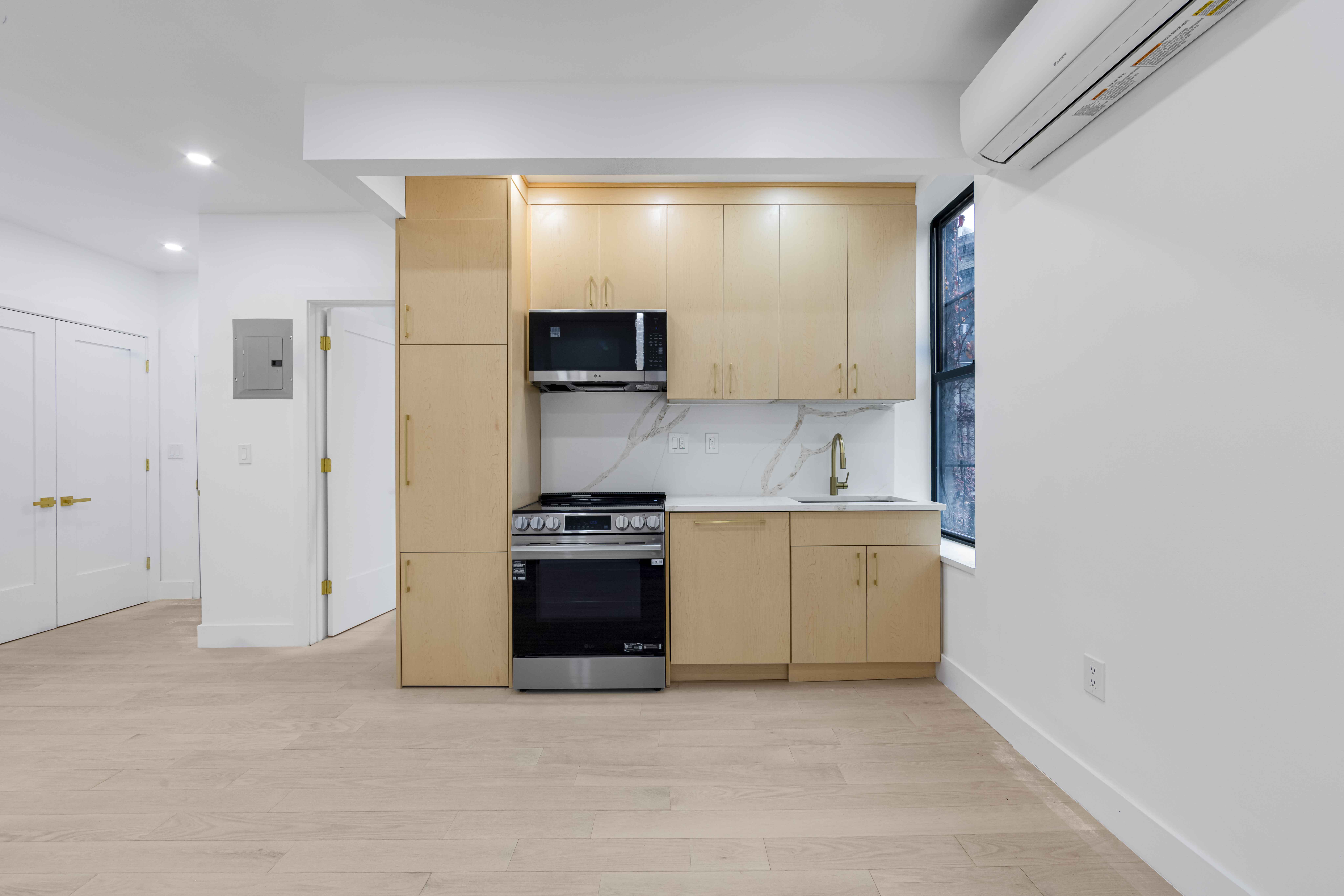 204 Flatbush Avenue, Unit 2L Brooklyn, NY 11217 - Photo 6 of 9 a kitchen with a refrigerator and a stove top oven