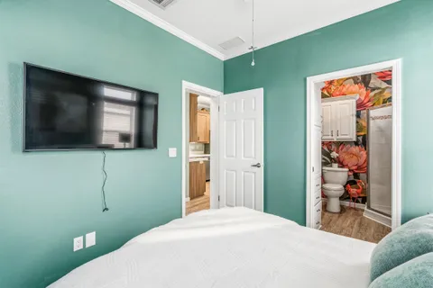 a bathroom with a sink a toilet a mirror and shower