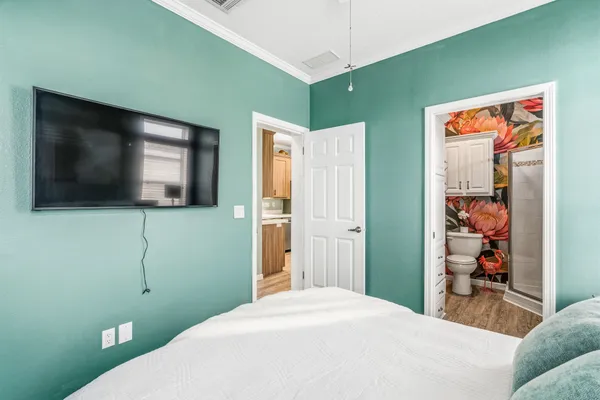 a bathroom with a sink a toilet a mirror and shower