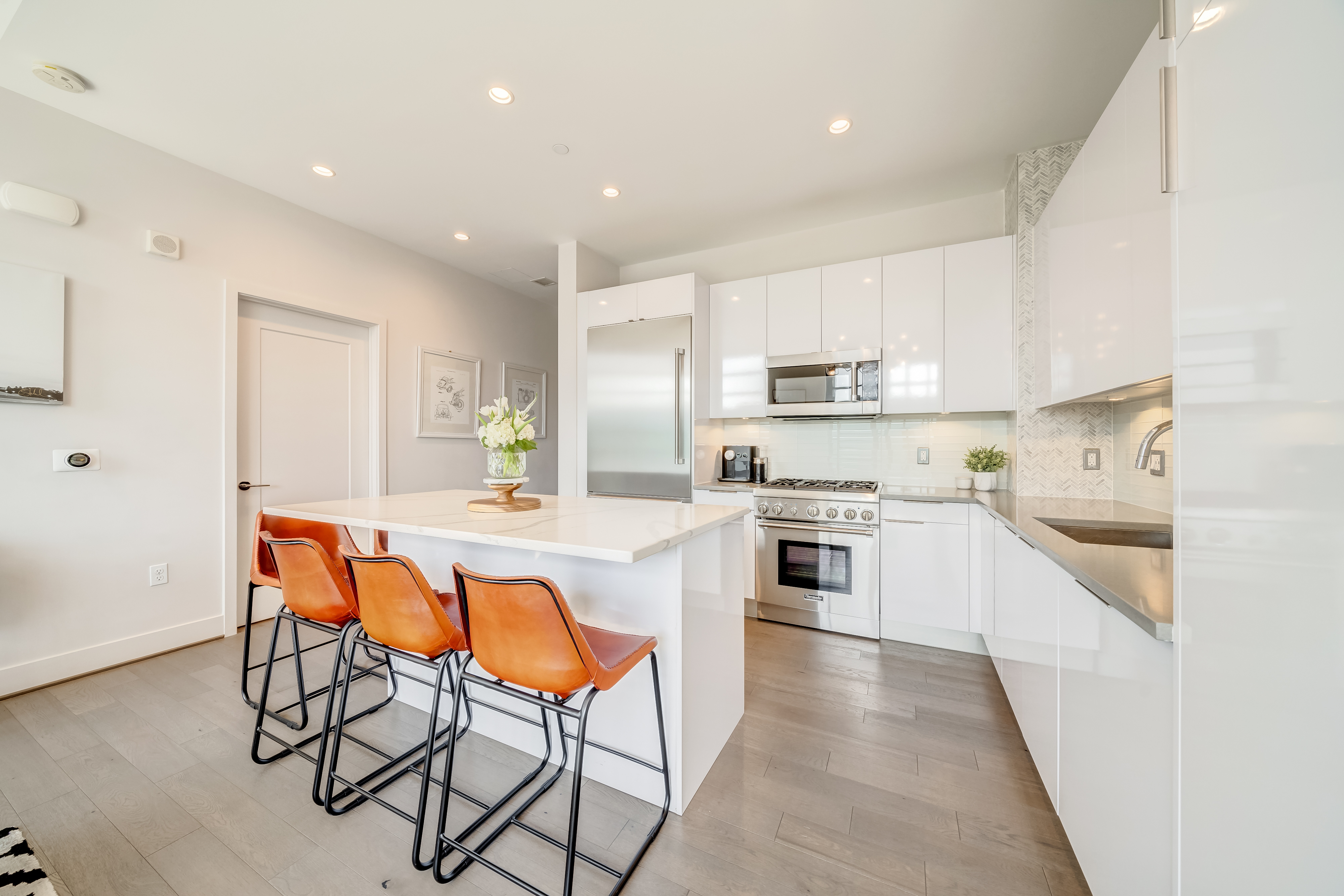 45 Sutton Square Southwest, Unit PH10 Washington, DC 20024 - Photo 12 of 44 a kitchen with stainless steel appliances a stove a sink dishwasher and a refrigerator