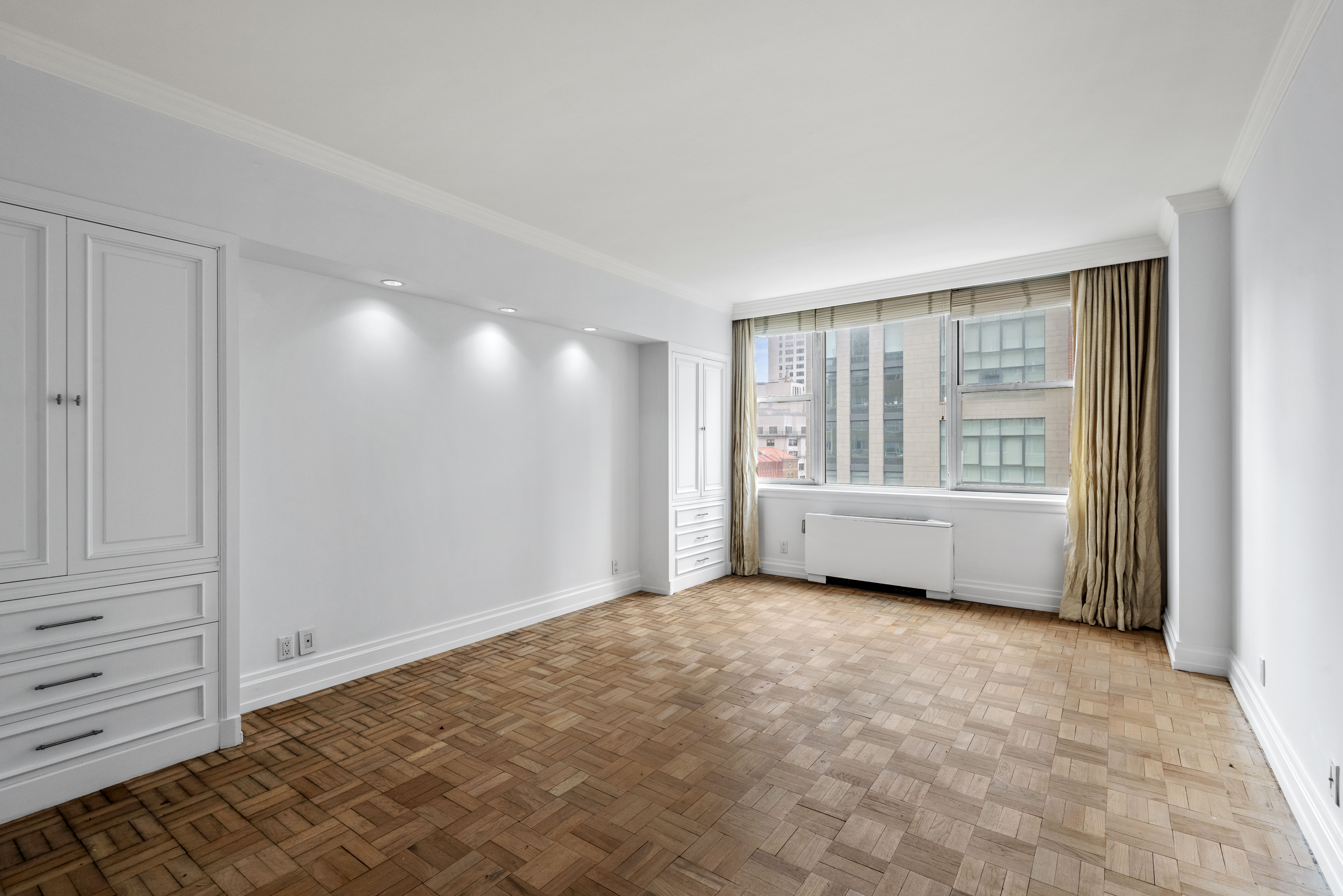 175 East 62nd Street, Unit 12A Manhattan, NY 10065 - Photo 21 of 24 a view of an empty room with a window