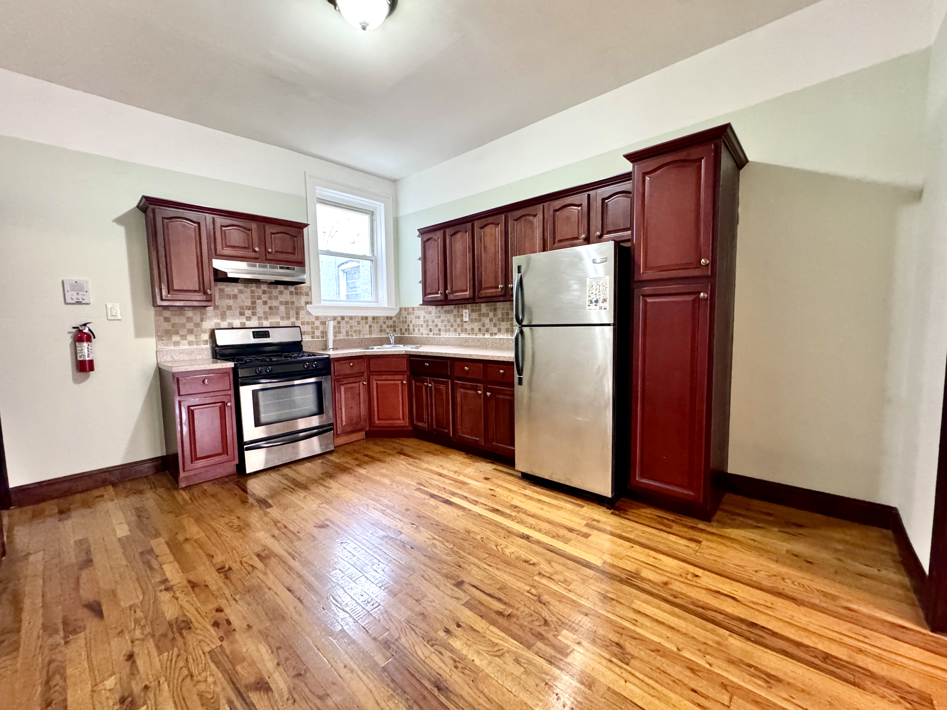 497 Park Place, Unit 4 Brooklyn, NY 11238 - Photo 9 of 14 a kitchen with stainless steel appliances granite countertop a refrigerator and a stove