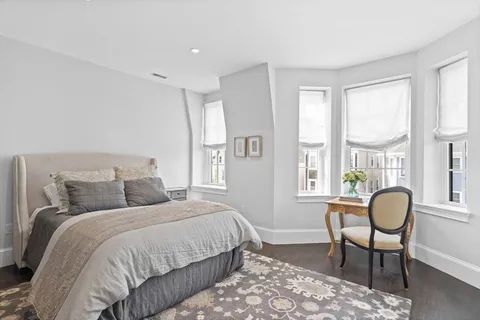 a bedroom with a bed and a large window