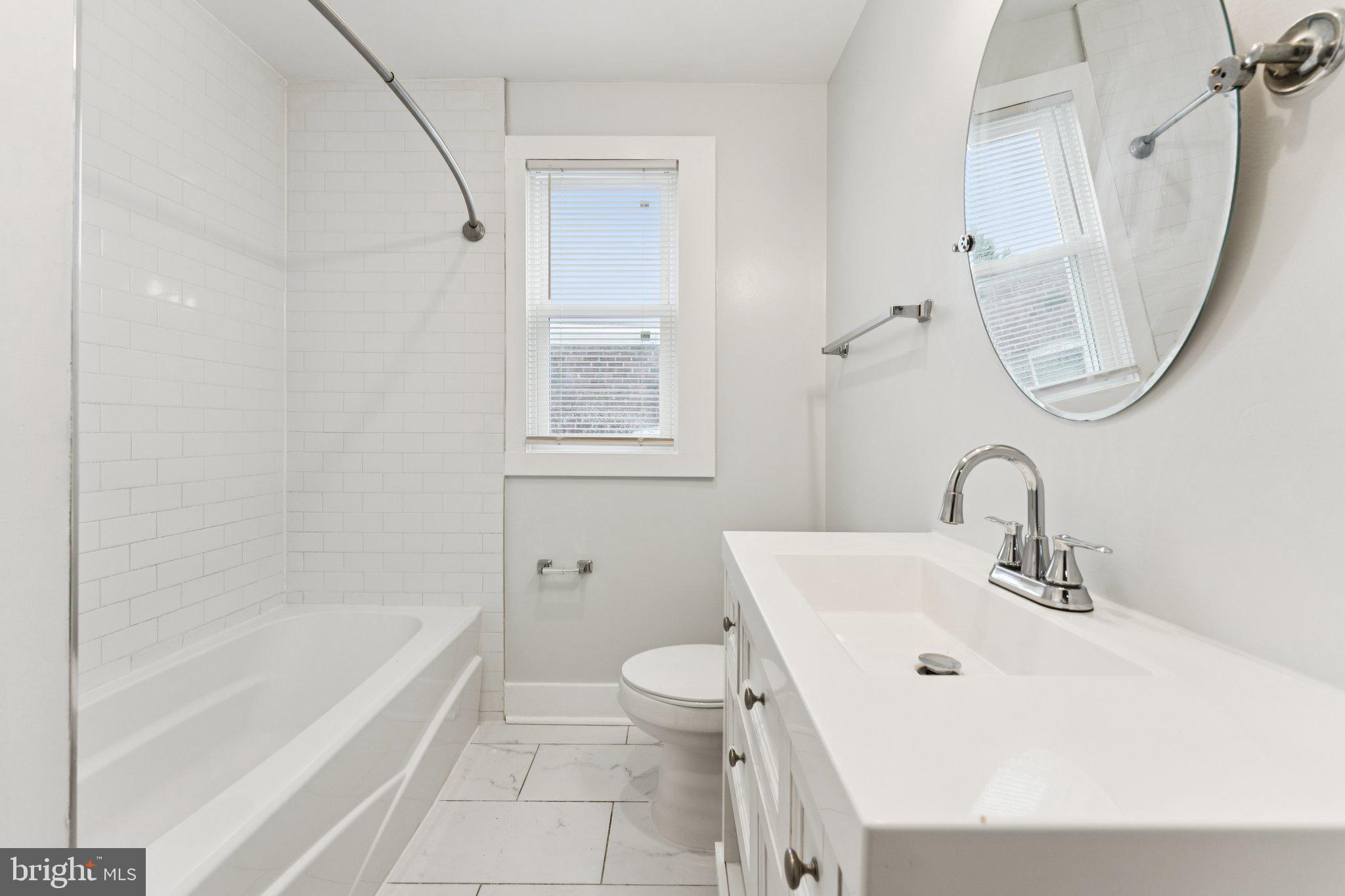 2822 28th Street Southeast Washington, DC 20020 - Photo 20 of 57 a bathroom with a sink a toilet and a bathtub