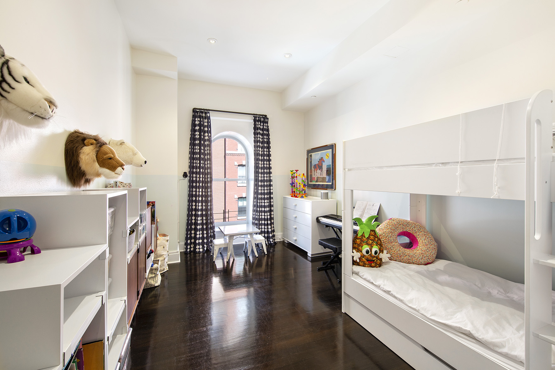 92 Laight Street, Unit 5I Manhattan, NY 10013 - Photo 7 of 12 a hallway with a couch and a book shelf