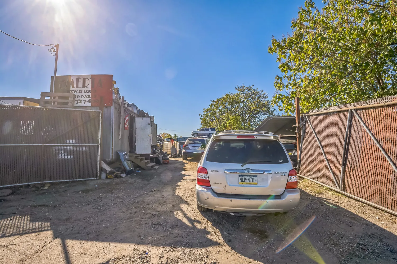 a view of a backyard with wooden fence