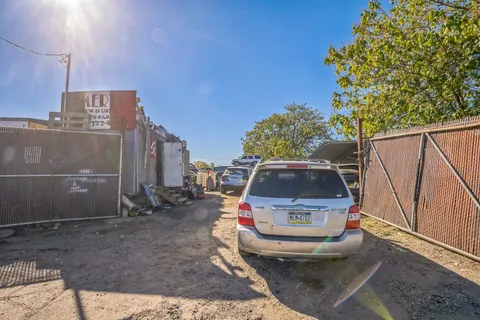 a view of a backyard with wooden fence