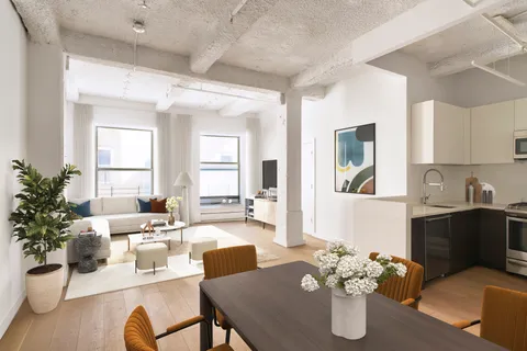a living room with furniture kitchen view and large windows