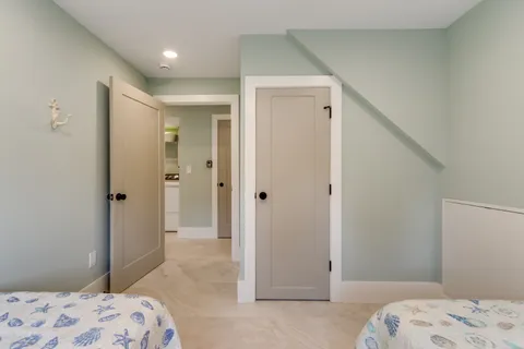 a bedroom with a bed and a painting on the wall