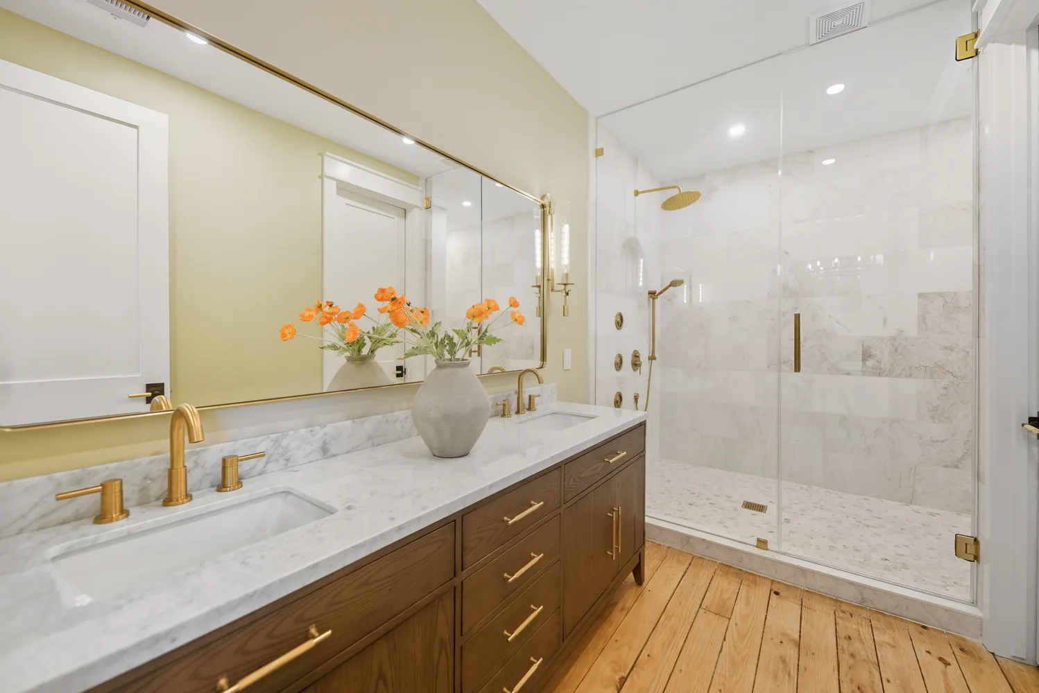 a bathroom with a granite countertop sink a mirror and shower